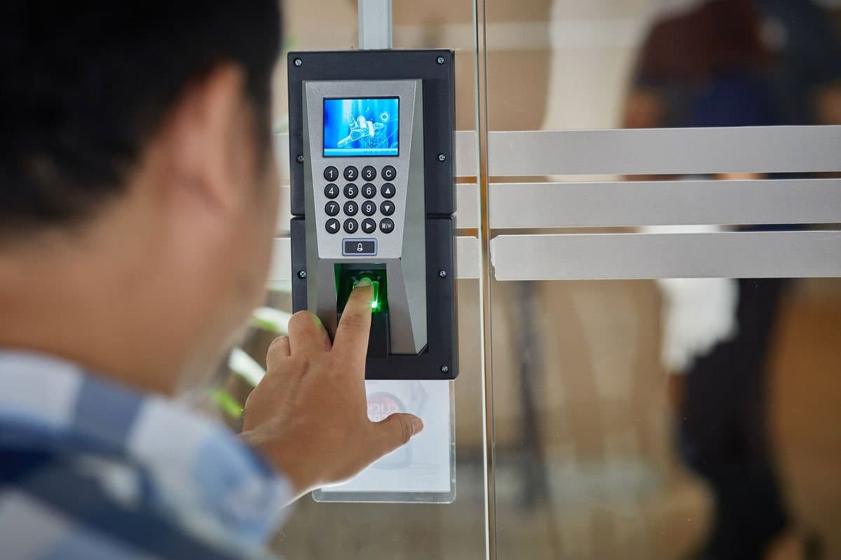 Access control keypad reader being used at a glass entry door — serving Carthage, TX